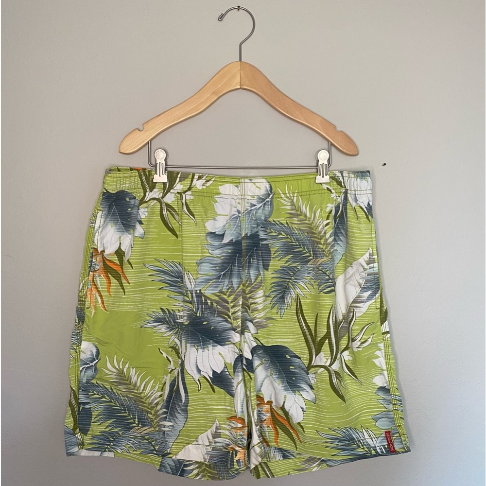 Tommy Bahama green and white Hawaiian print swim trunks.